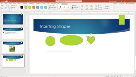 A picture of a user inserting shapes in PowerPoint. The user is inserting a heart shape with a default size.