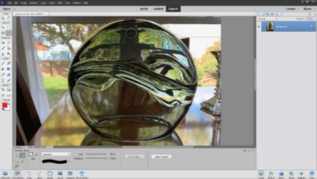 A picture of a user making a selection with the Selection Brush Tool in Photoshop Elements.