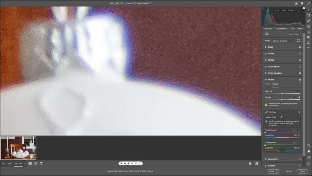 A picture of a user removing chromatic aberration fringe within the Optics panel in Camera Raw in Photoshop.